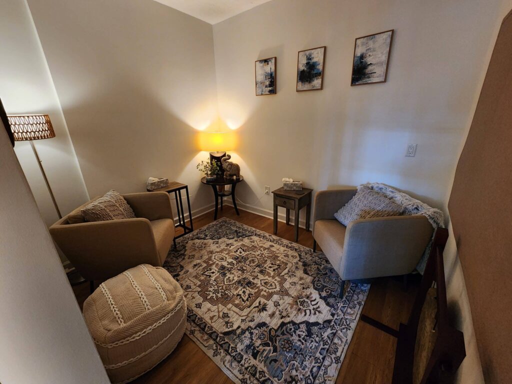 A Bedroom With A Bed And A Chair In A Room